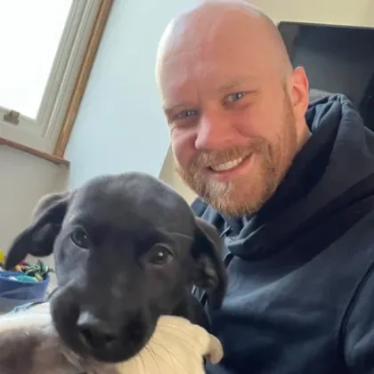 Steve with a black puppy