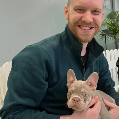 Steve holding a French Bulldog puppy